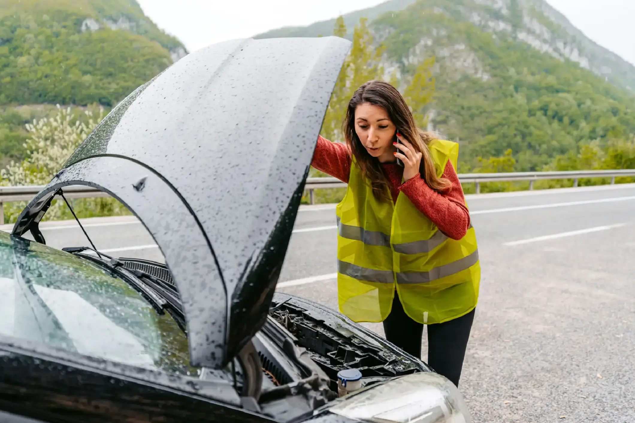 Concerned driver with open car hood